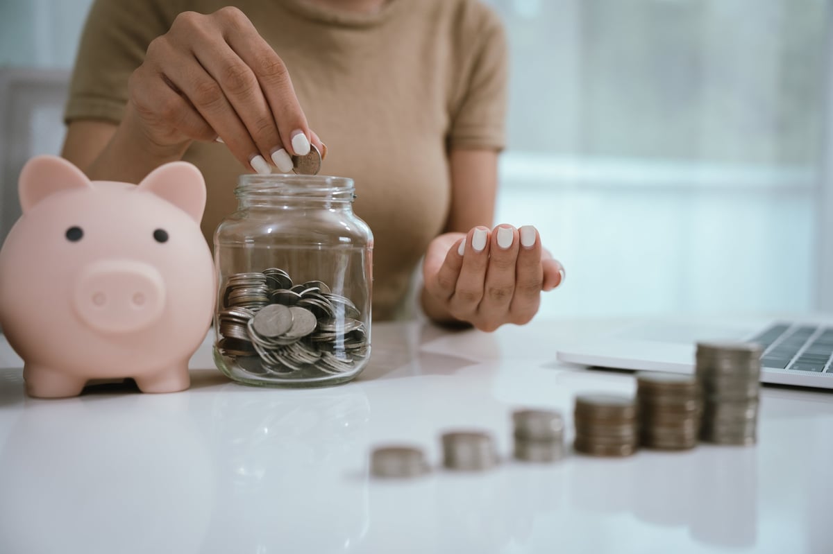 Woman planning budgeting with coins and piggy bank